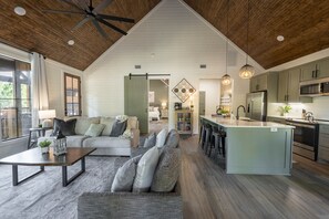 Experience comfort at the heart of our cabins living room & kitchen. The perfect blend of rustic charm & modern elegance creates a cozy, inviting atmosphere. Cozy up by the fireplace, savor delicious meals in our stylish kitchen.