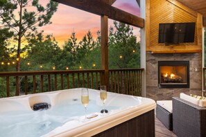 Enjoy the ultimate luxury of a 4-person spa, the gentle glow of string lights overlooking the treetops in the backyard. 