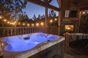 Enjoy the ultimate luxury of a 4-person spa, embraced by the gentle glow of string lights, overlooking your backyard. Enhance your outdoor space with a captivating fireplace and a cozy sitting area that offers stunning tree-top views.