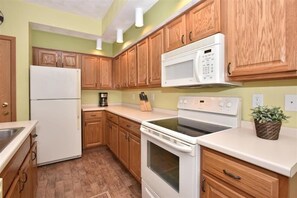 Indoors, Kitchen, Refrigerator, Cooktop, Microwave