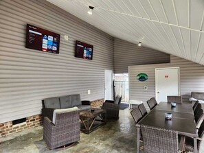 Outdoor space w/tables and seating for 10, 2 58" Smart TVs, located by the pool!