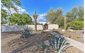 Extensive desert landscape in front yard greets you as you enter locked entry