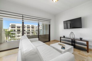 living area with air conditioning and television