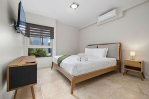 Bedroom with king bed, TV and own AC unit.
