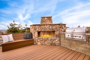 Cozy outdoor fireplace and bench seating.