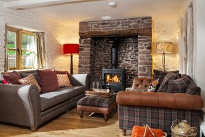 Cosy up on the sumptuous sofas by the wood burning stove in the sitting area