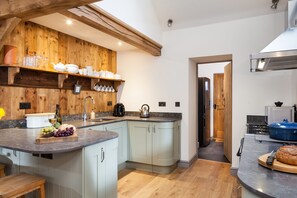 Bespoke well-equipped kitchen, with Tassimo coffee machine and sit-up bar with two stools