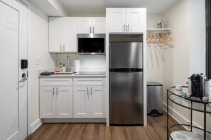 Enjoy making home-cooked meals or getting take out in this lovely kitchen with stainless steel and full-size refrigerator.