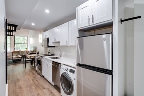 Enjoy making home-cooked meals or getting takeout in this lovely kitchen with stainless steel appliances and full-size refrigerator