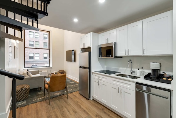 Enjoy making home-cooked meals or getting takeout in this lovely kitchen with stainless steel appliances and a full-size refrigerator