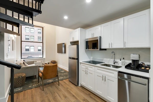 Enjoy making home-cooked meals or getting takeout in this lovely kitchen with stainless steel appliances and a full-size refrigerator