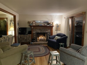 The sitting room with fireplace and tv.