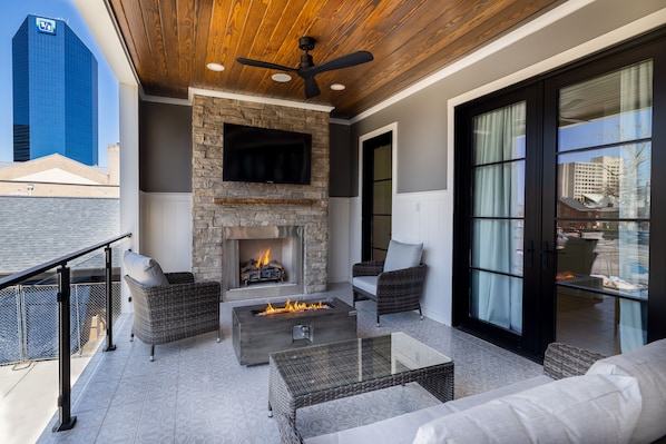 Outdoor patio with built in grill, fire pit, and outdoor TV