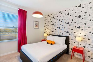 Mickey Mouse themed bedroom of the townhouse in Davenport Florida - Stunning views from the bedroom window - Plush double bed for restful nights - Inviting atmosphere designed for a restorative sleep