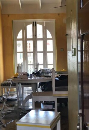 Dining table with balcony door showing behind it