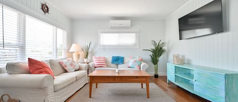 Family room wth smart TV and pull out sofa bed.