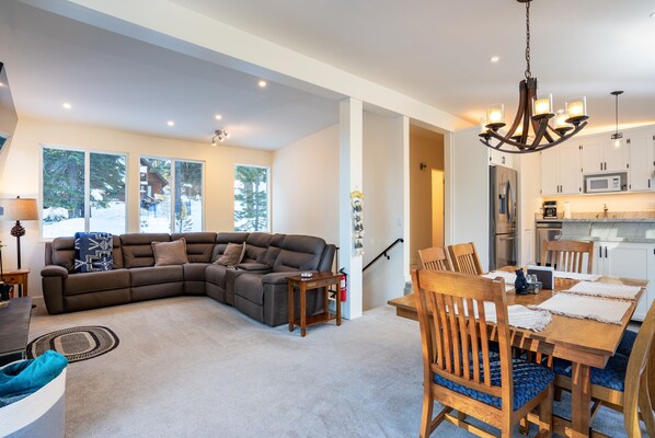 Enjoy a bright and airy open floor plan that seamlessly connects the living room, dining area, and kitchen—perfect for gathering and entertaining