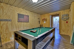 Game room on lower level with multi top game table including pool