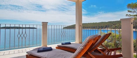 Amazing sea view from the roofed terrace with dining set and sun loungers of the luxury villa Korcula Beach divine with boat mooring
