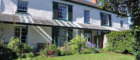 Sages front view (Flat & garden beyond hedge, below right two upstairs windows)