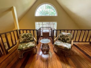 Large loft-style bedroom with seating area.