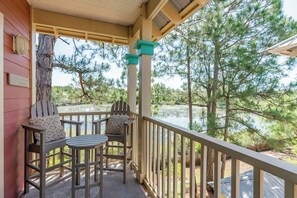 Enjoy the peace and beauty from the upstairs backyard balcony with a cocktail table and chairs. See if you can spot alligators and turtles in the pond with our binoculars!