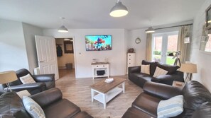 Large living room, seating eight, leading onto the private patio