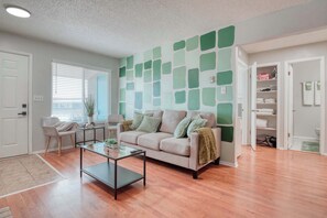 The painted walls in varying shades of green create a refreshing and tranquil atmosphere, complemented by lush indoor plants that bring nature indoors.
