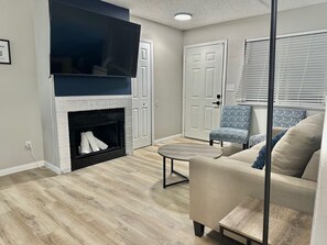 Step into this beautifully designed living room, featuring a plush 3-seater sofa adorned with soft throws for added comfort. Relax with your favorite show on the smart TV, or cozy up by the indoor fireplace for a warm, inviting atmosphere.