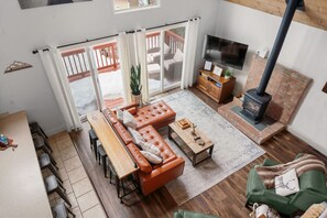 Looking down at the heart of the chalet, where wood ceilings, rich colors, and cozy vibes create the perfect escape. 