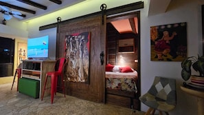 Custom barn door hides your queen size bed and loft/window area.