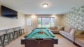 Game Room with pool table, large TV and ample seating !