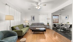 Living room has seating for 6+, ceiling fan and light, plus 3 lamps