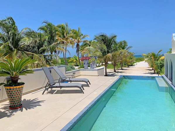 A beachfront infinity pool with an ocean view.