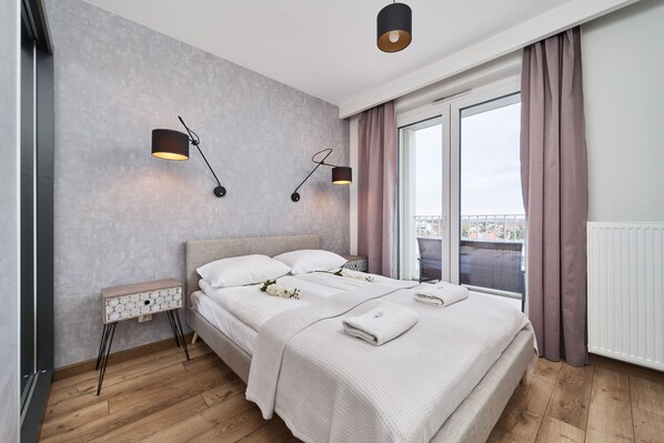 Modern bedroom with a double bed and wardrobe with mirror.