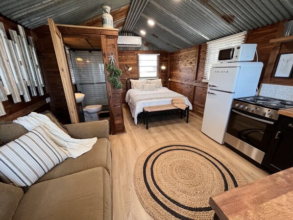 Rustic cabin with aged, corrugated metal ceiling