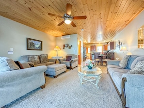 Cobblestone Cove Villa 4 has an open layout great room with a living room, dining room, kitchen, and half bathroom.