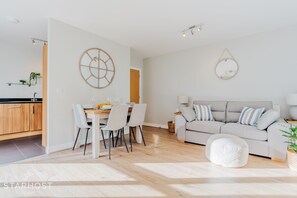 The living room connects to the modern kitchen with full range of appliances