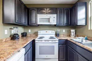 The kitchen has all the appliances you need!  Full with all the essentials and a fridge, microwave, oven, dishwasher, coffee machine and toaster.