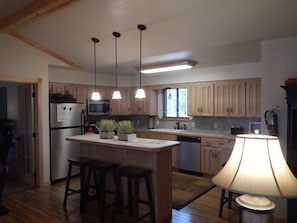 "Indoors","Kitchen","Lamp","Refrigerator","Floor"