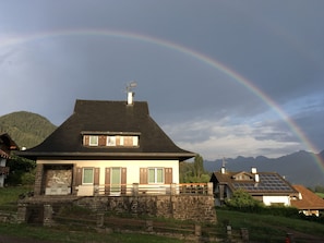 The house at sunset with an amazing rainbow
