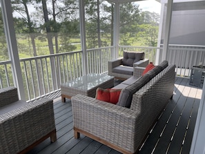 Screen porch w/views of wetlands & golf course.  Relax on comfortable seating. 