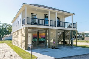 Covered parking for 2 SUVs and driveway parking for 2 more vehicles. Sit on the covered porch with and take in the gulf breeze.