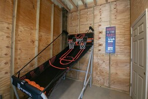 "Game On! Enjoy Hours of Fun in the Enclosed Game Room with a Basketball Goal - Perfect for Friendly Competitions and Entertaining Guests of All Ages"