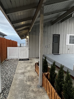 Walkway to front door. Back door on right. Keep walking through 2nd gate. 