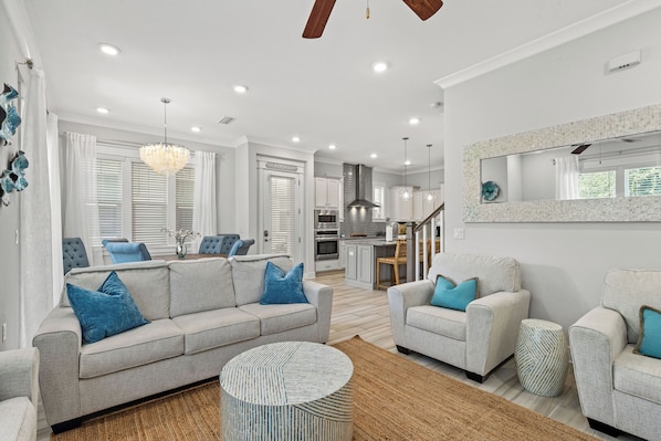 View of newly renovated living room (w/ queen sleeper, dining, & kitchen 