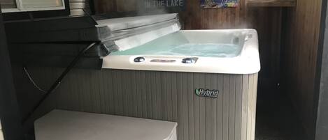 Enclosed hot tub in front entrance of suite 