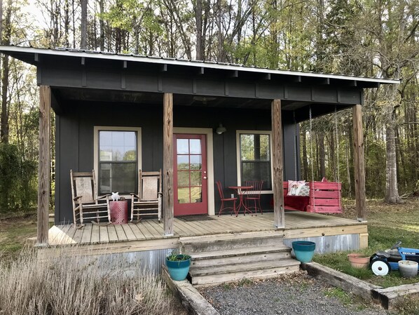 Ample front porch with a view of the sunrise and pond.