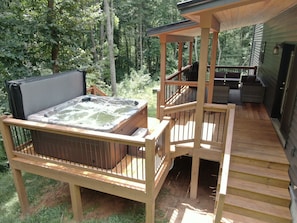 Deck with hot tub and outdoor seating
