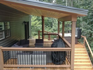 Deck with hot tub and outdoor seating